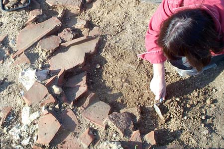 Excavating a deposit of tiles